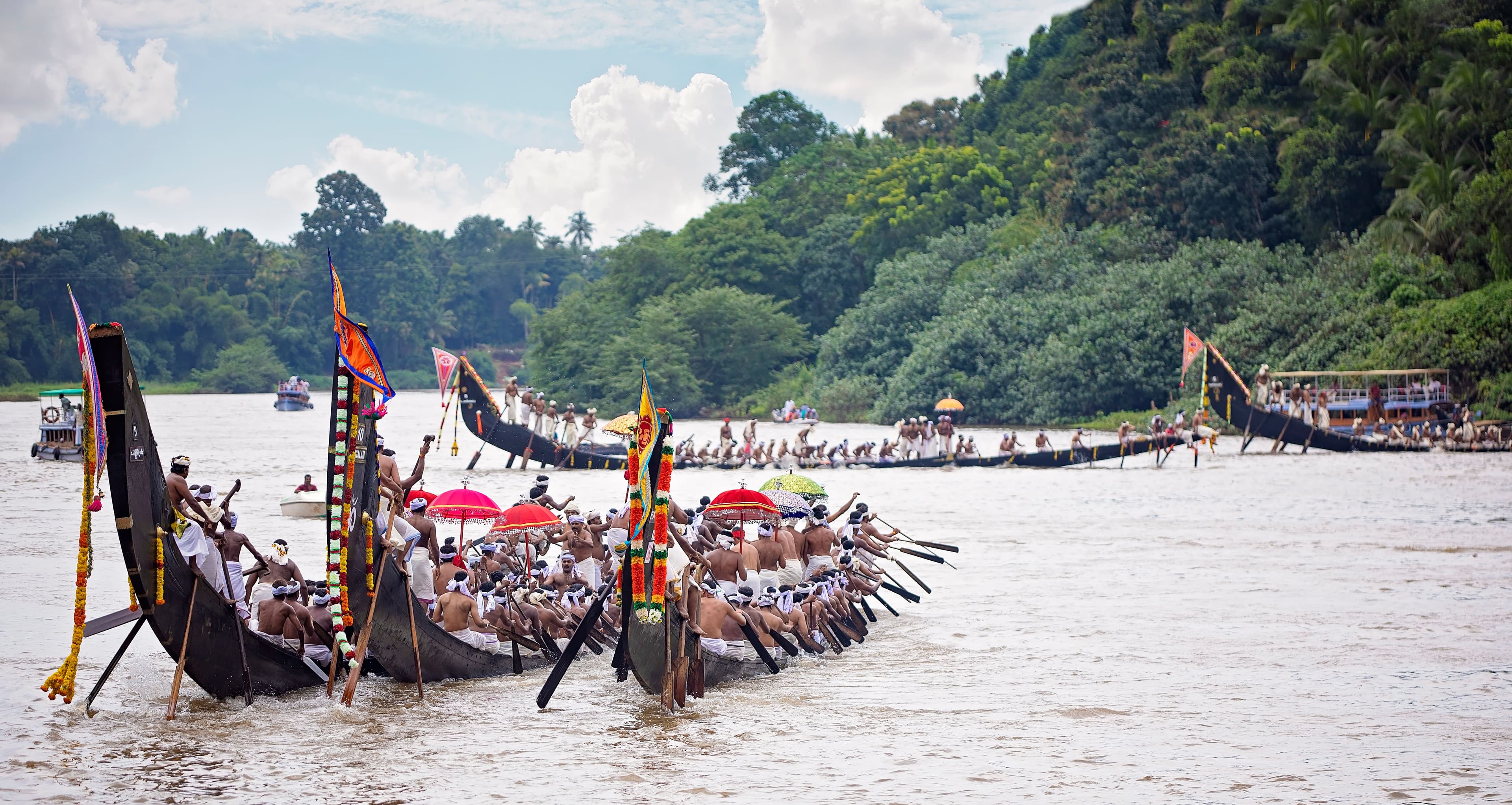 Decorated Aranmula palliyodams and rowers gathered on the Pamba River