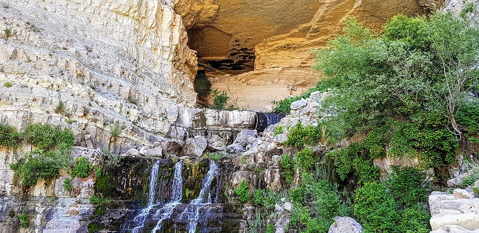 Water emerging below the cave at Afqa.