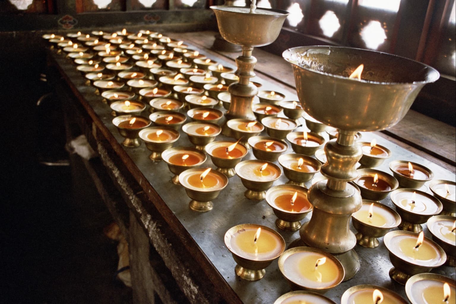 butter lamps at Tango Monastery, Thimphu valley, Bhutan.  Copyright (c) 2002 William L. Devanney