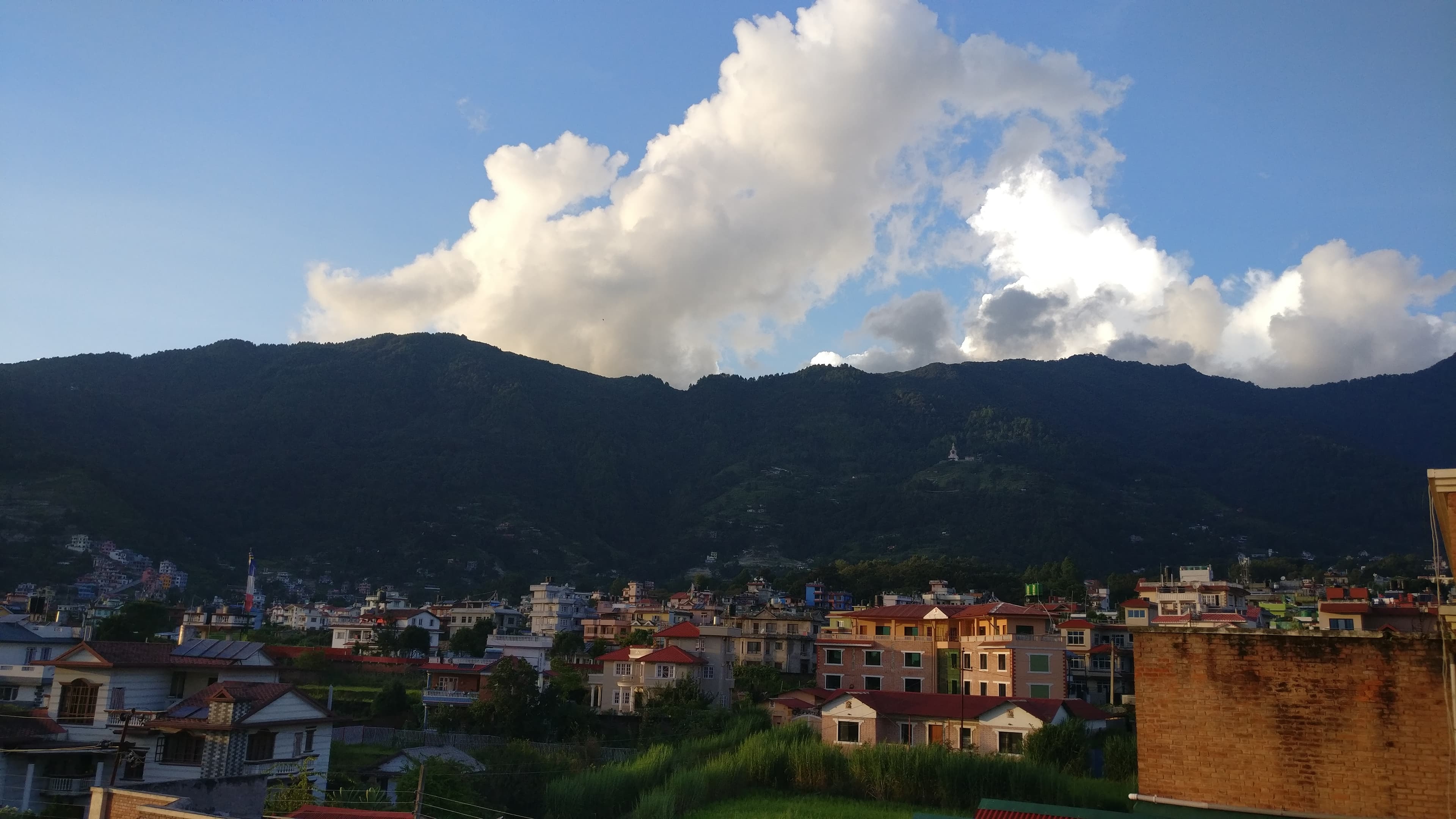 Budhanilkantha town at the foot of Shivapuri hills visible from a building terrace