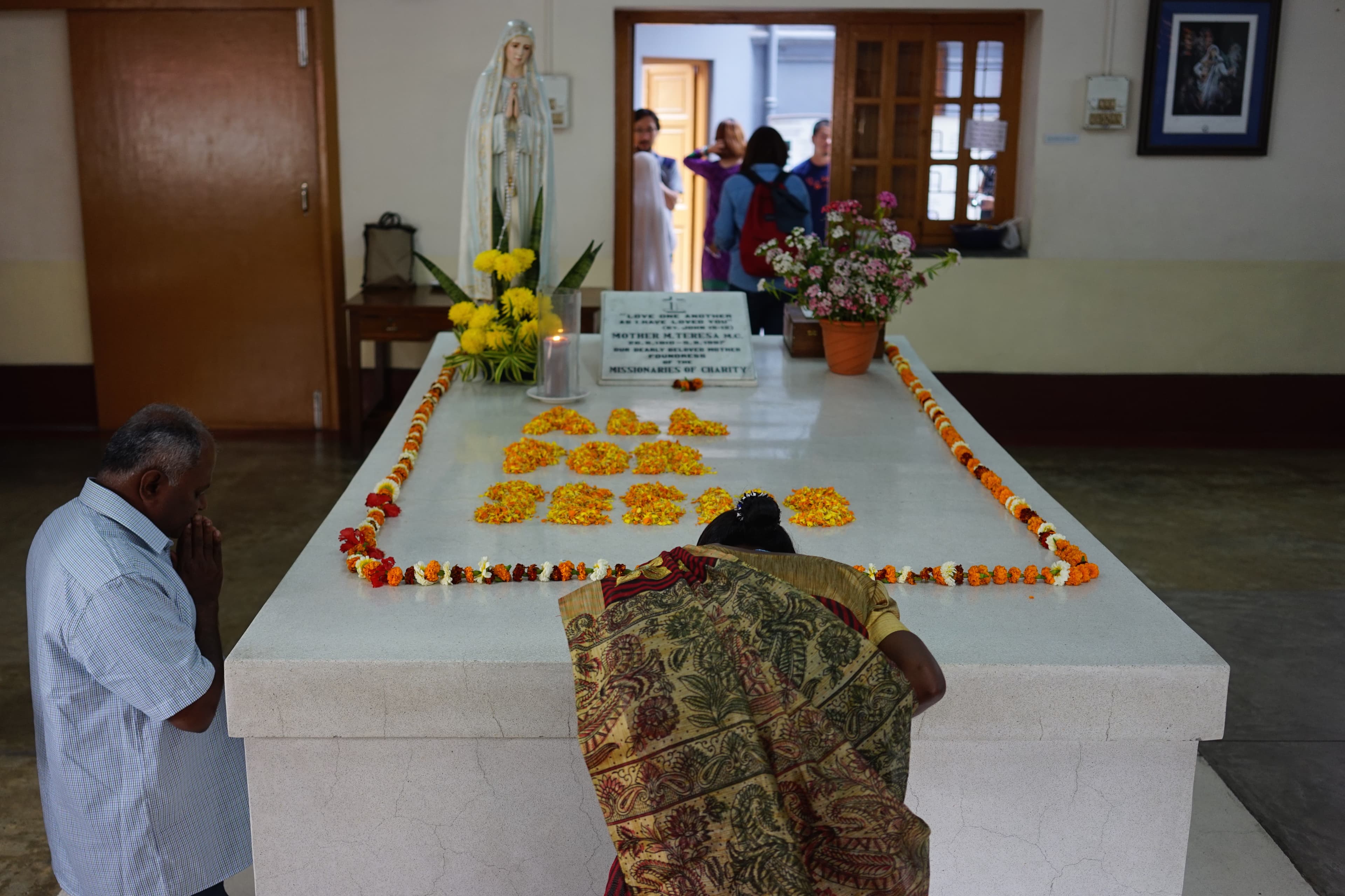 Pilgrims praying at Saint Teresa of Calcutta’s tomb inside Mother House