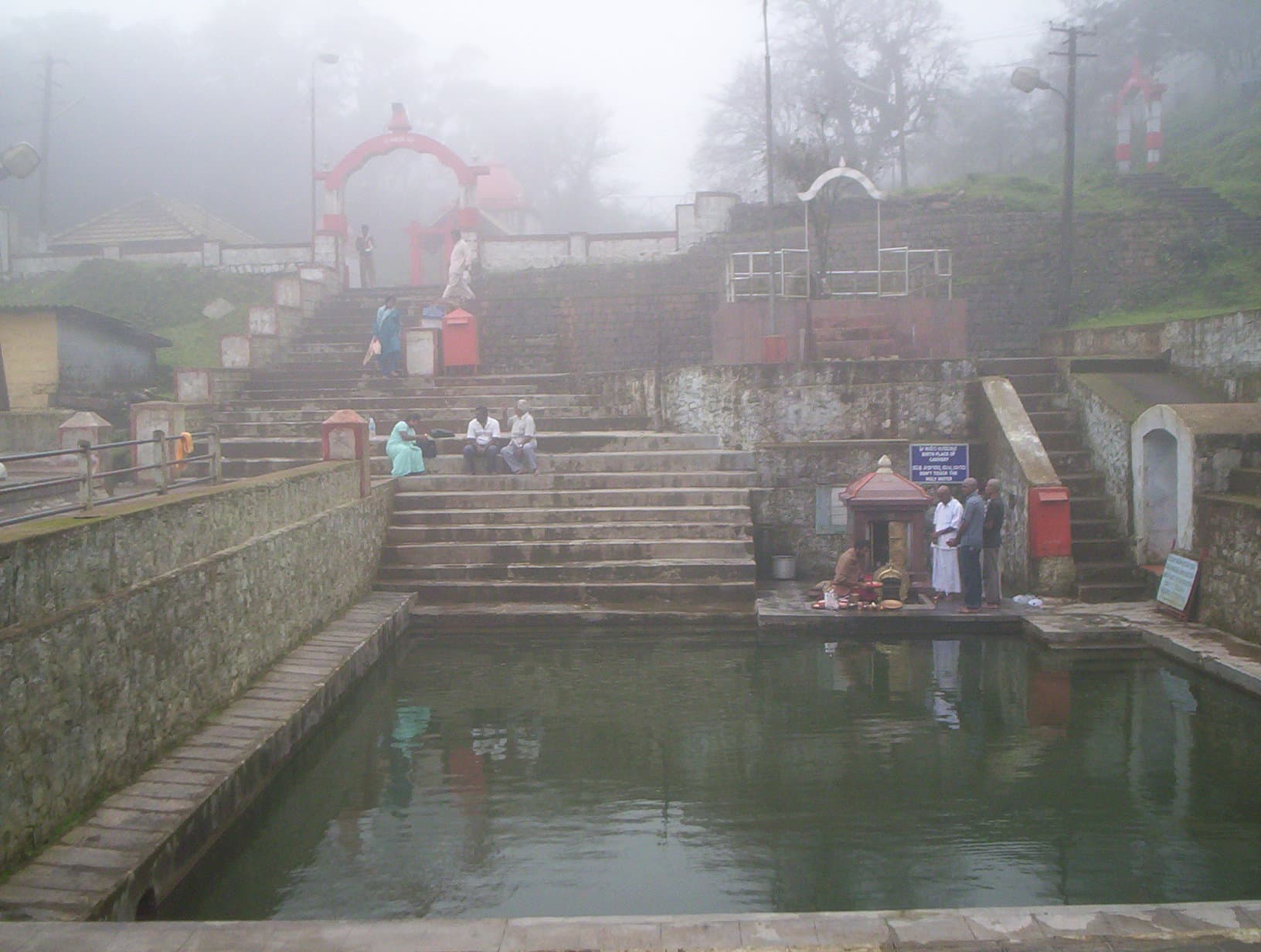 The temple and water basin at Talakaveri in mist.